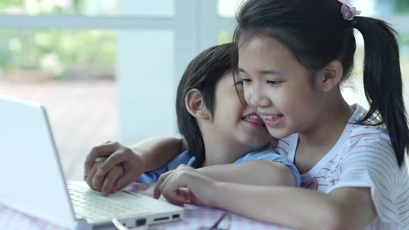 Cute Asian Children Using Tablet Together