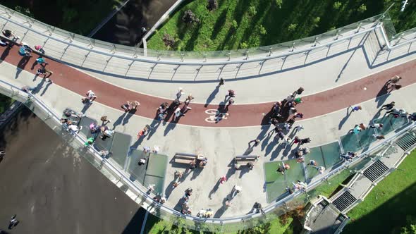 Aerial Top View of Pedestrian Glass Bridge with a Crowd of Walking People