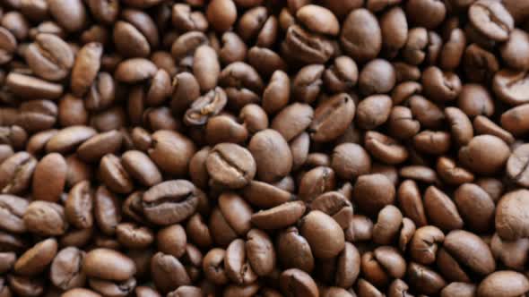 Arabica coffee beans shallow DOF tilt 4K 2160p UHD footage - Slow tilting over roasted coffee beans 