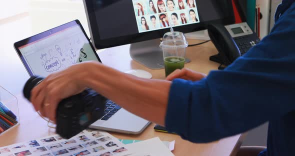 Male executive working over laptop at his desk 4k