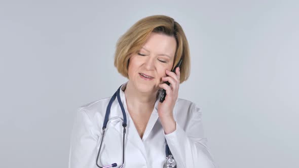 Old Doctor Talking on Smartphone White Background