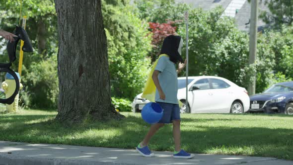 Two kids out trick or treating on halloween with costumes