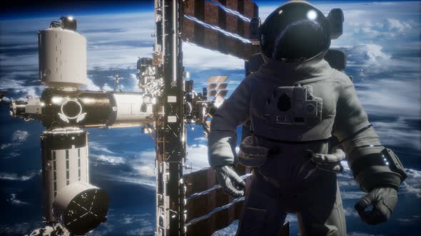 International Space Station and Astronaut in Outer Space Over the Planet Earth alt
