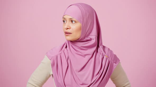 Annoyed Mature Muslim Woman in Hijab Feeling Irritation Crossing Her Arms and Inhaling Crossly Pink