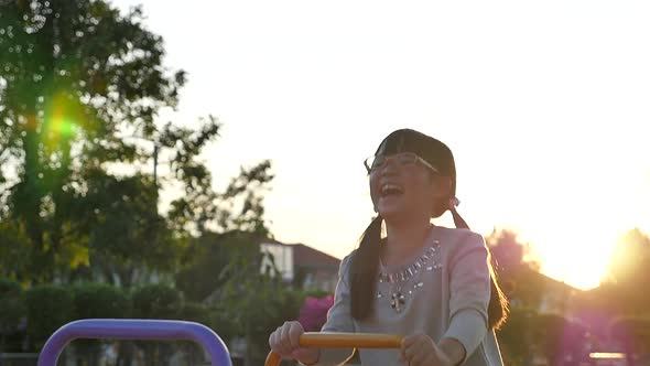 Girl Riding Seesaw Board With Big Smile And Happy Face