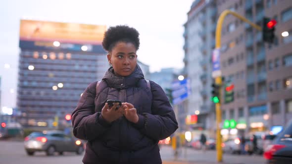 Slow motion young black woman outdoor using smart phone