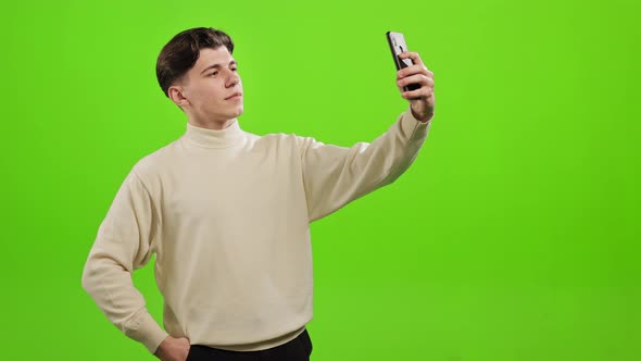 A Man is Taking a Selfie on a Smartphone