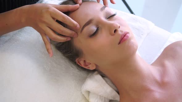 Woman Gets Facial and Head Massage in Luxury Spa