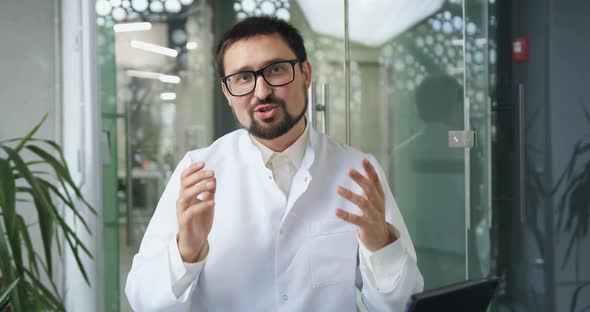 Bearded Doctor Finishing His Speech with Clapping Hands During Online Conference