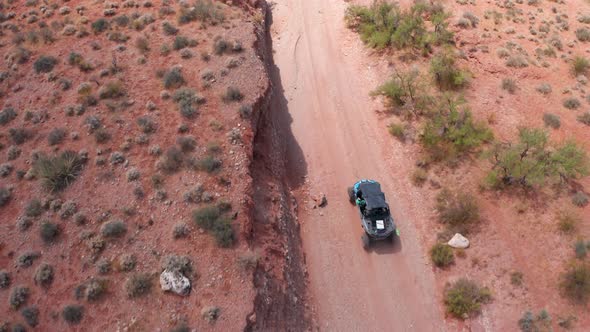 Aerial shot of dune buggy on dirt road in Utah.