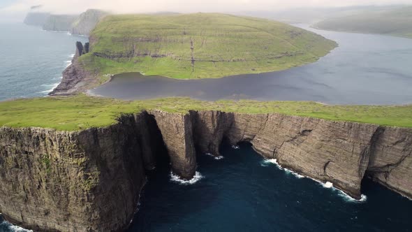 Aerial view of tourists English Slave cliff on North Atlantic sea, Faroe island.
