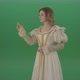 Satisfied Woman In A Medieval Dress Flips A Touchscreen And Smiles Isolated On Green Background - VideoHive Item for Sale