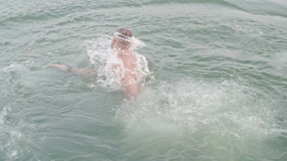 Man Diving Into Water from Pier