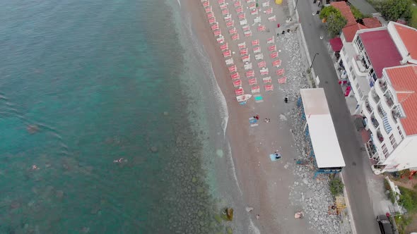 Birds Eye View Aerial Drone Footage of Beach in Sutomore Montenegro in the morning.