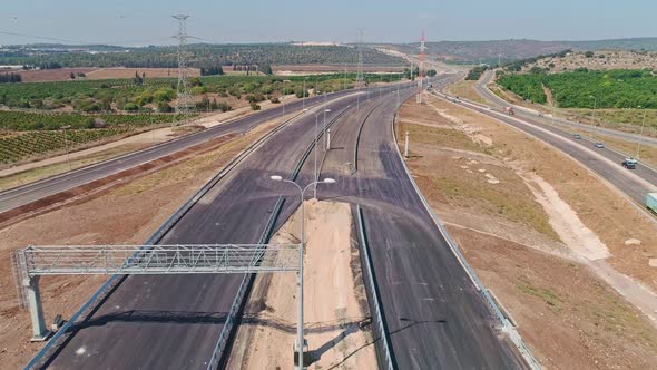 Aerial footage of large highway construction project with tunnels and bridges