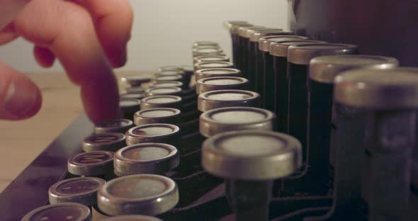 Special macro dolly shot hovering over old typewriter keys with male hand typing