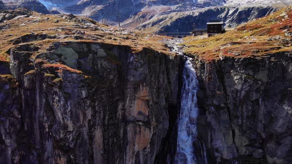 Natural Waterfall Flowing Down On Mountain Cliff From Spillway Of Weisssee Gravity Dam In Austria. -