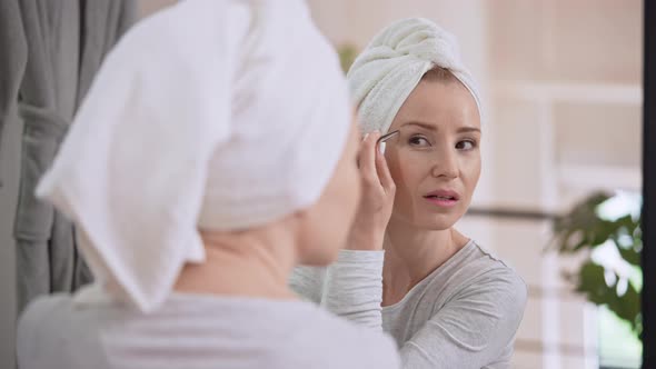 Caucasian Adult Woman Plucking Eyebrows