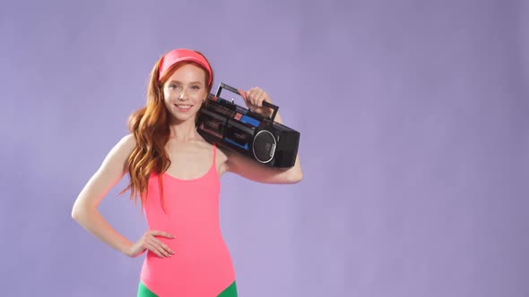 Redhaired Girl with Lovely Freckles Holding Portable Cassette Player on Her Shoulder