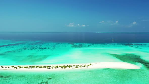 Aerial drone view sky of tranquil shore beach lifestyle by turquoise lagoon and white sandy backgrou