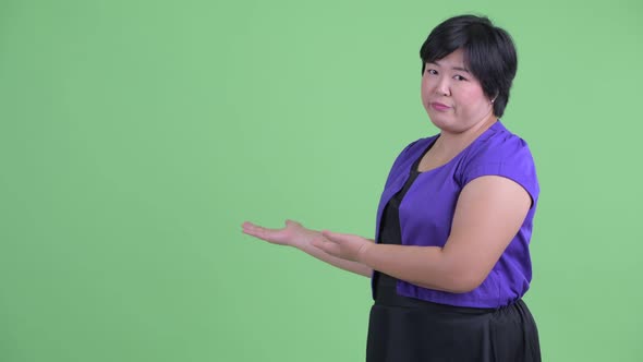Stressed Young Overweight Asian Woman Showing To the Back