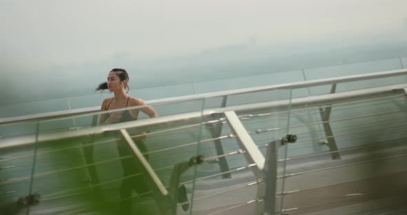 Strong Sportswoman Running Fast on Bridge