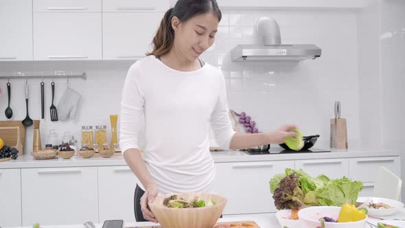 Young Asian woman making salad healthy food  use organic vegetables.