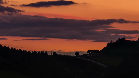 Bloody Evening Sky after Sunset with Road Traffic at Night