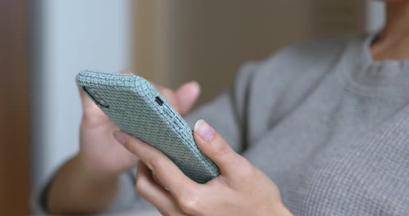 Woman work on cellphone at home