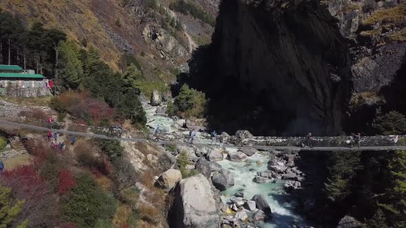 Hinged Bridge Above River In Mountains. Nepal