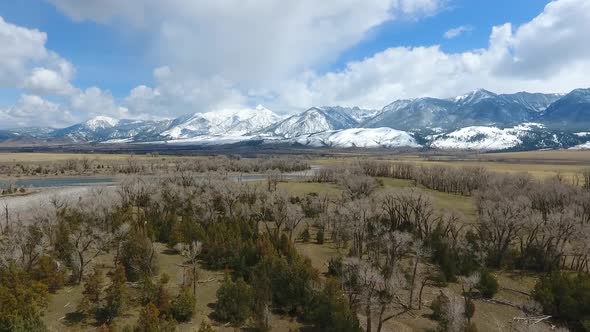 Flying Over Desert Plains Towards Stunning Snowcapped Mountains