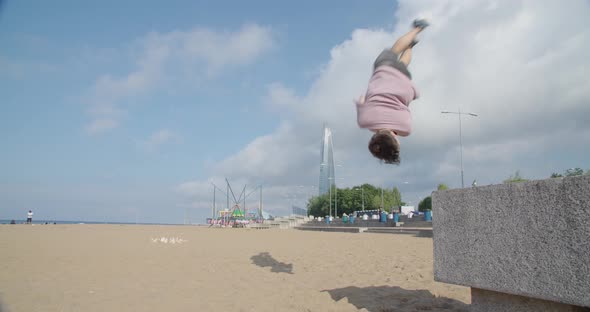 Man Engaged in Parkour on the Sandy Shore Free Space for Inscriptions