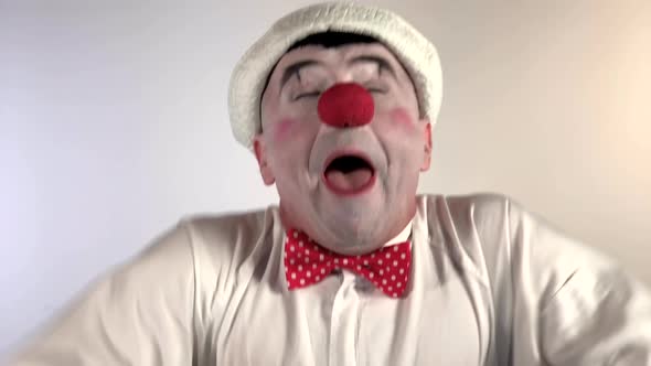 Emoji Clown - Sneezing Face. A mime clown sneezes and has a drop of mucus on his nose, then he puts