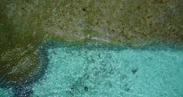 Daytime drone copy space shot of a sunshine white sandy paradise beach and turquoise sea background 