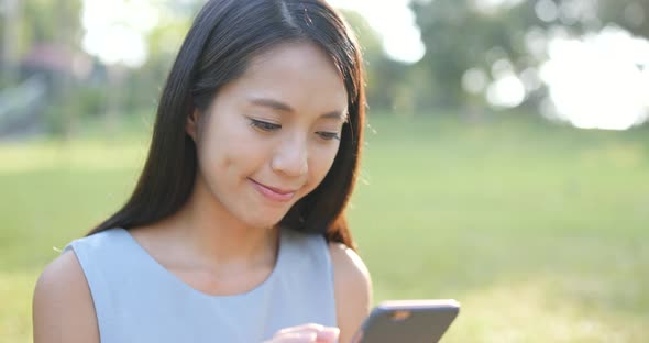 Woman use of smart phone in the park