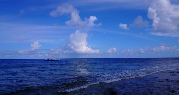 Daytime flying island view of a white sandy paradise beach and aqua blue water background in best qu