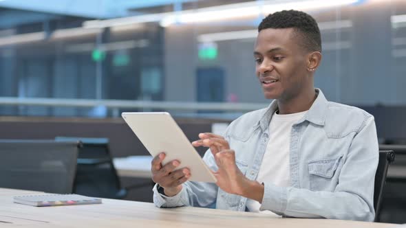 Successful Young African Man Celebrating on Tablet