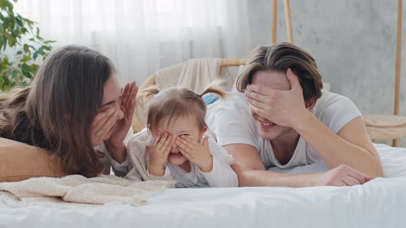 Happy Caucasian Parents Caring Mom and Loving Father Playing Hide and Seek with Toddler Baby Infant