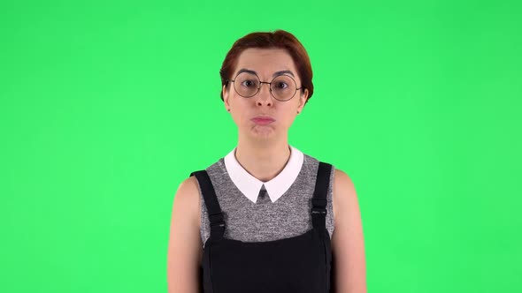 Portrait of Funny Girl in Round Glasses Is Saying Wow. Green Screen