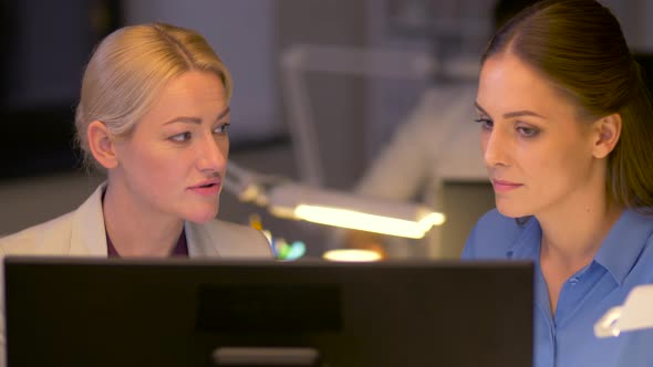 Businesswomen with Computer Working Late at Office 