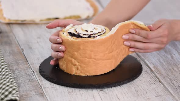 Pastry Chef Making Sponge Cake with Vertical Layers and Blackcurrant Jam