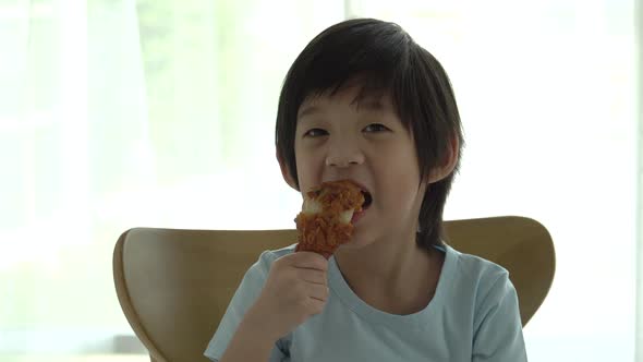 Cute Asian Child Eating Fried Chicken