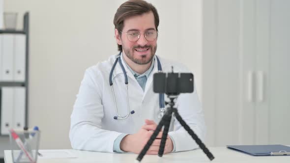 Young Male Doctor Recording Video on Smartphone