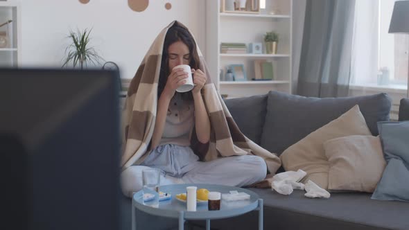 Sick Woman Drinking Hot Tea at Home