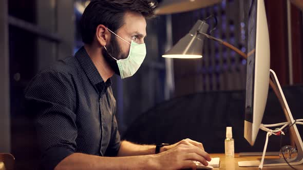 Man In Face Mask Working In Office. Businessman In Mask Protection Epidemic Coronavirus.