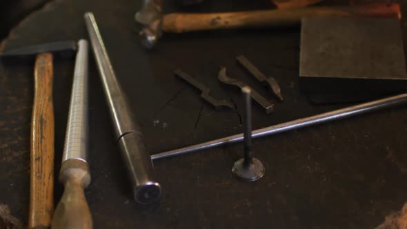 Close up of diverse jeweller tools lying on desk in workshop