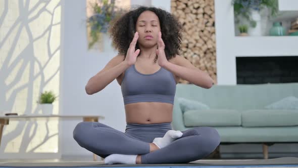 Young African Woman Meditating on Yoga Mat at Home