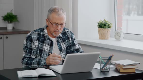 A Thoughtful Elderly Person Manages Household Finances Calculates Expenses