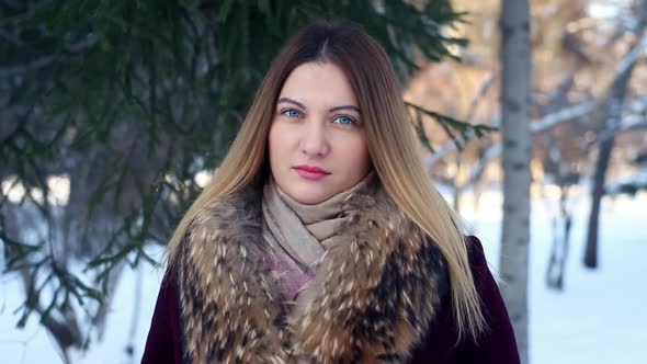 Portrait of a Fashionable Sexy Beautiful Girl in the Background of a Winter Forest