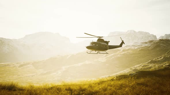 Slow Motion Vietnam War Era Helicopter in Mountains